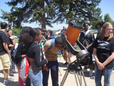 An image of students looking through a solar telescope